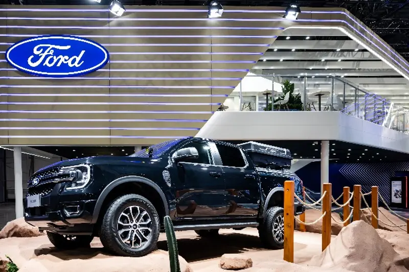 A black truck parked in a showroom

Description automatically generated